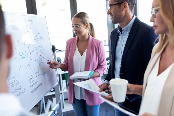 image: coworkers discussing SEO strategy in a marketing agency