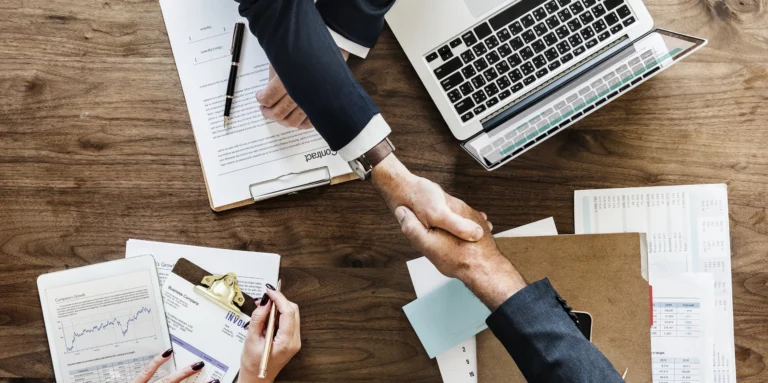 image: two people making a deal in a seo agency, shaking hands