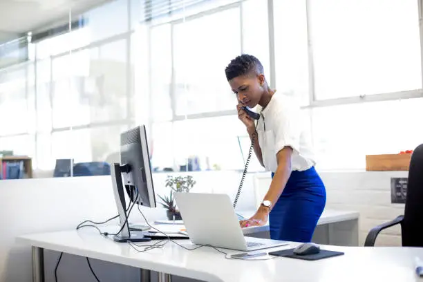 picture - a woman working in an SEO agency, answering a phone